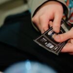 Close-up of hands holding cinema tickets, capturing a moment of anticipation for movie enthusiasts.